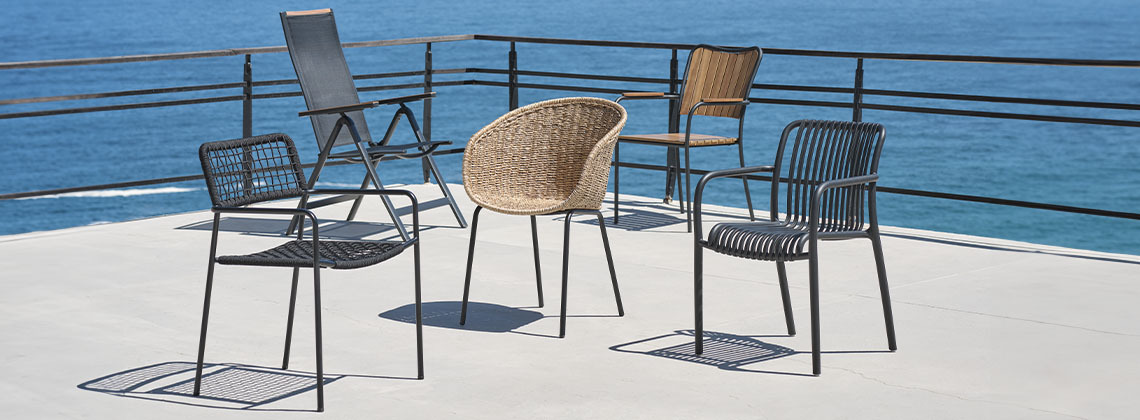 Una selección de cinco sillas de jardín en una terraza con vistas al mar 